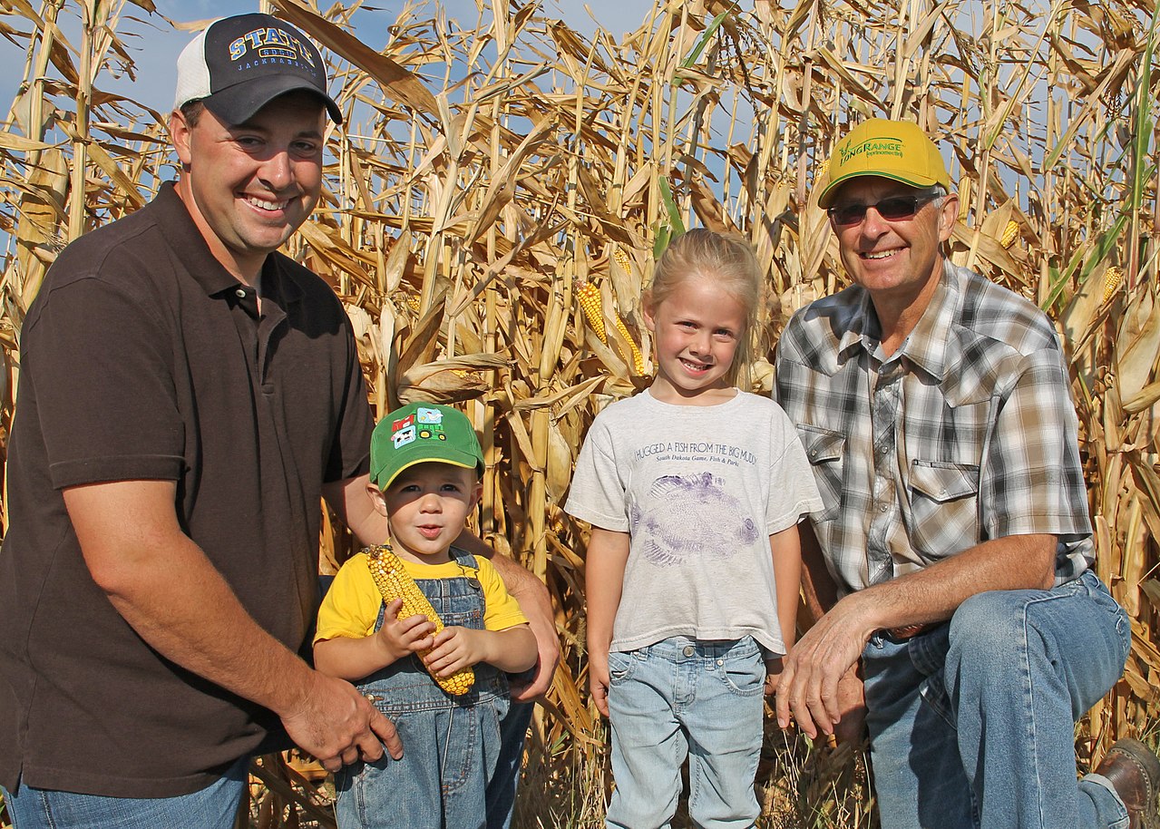 Wide view of a diversified organic farm showing multiple crop fields in different stages of rotation